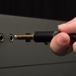 person-plugging-audio-cable-3531847
