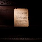 photo-of-music-notes-leaning-on-wooden-piano-3507989