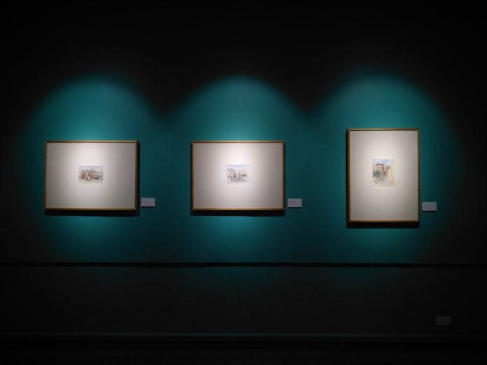three-paintings-hanging-in-gallery-1674049