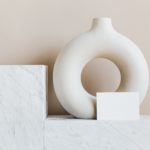 decorative-vase-of-ring-shape-with-blank-card-on-marble-4203098